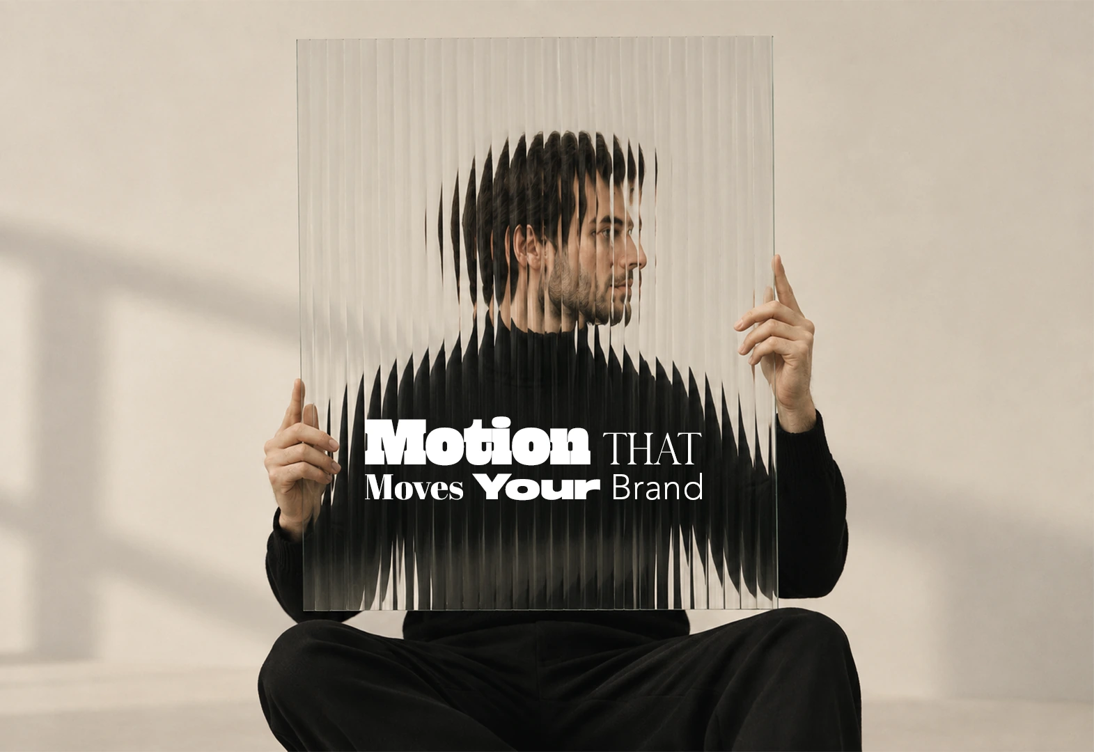 Man holding reeded glass that blurs his face, on a "Motion that moves your brand" poster